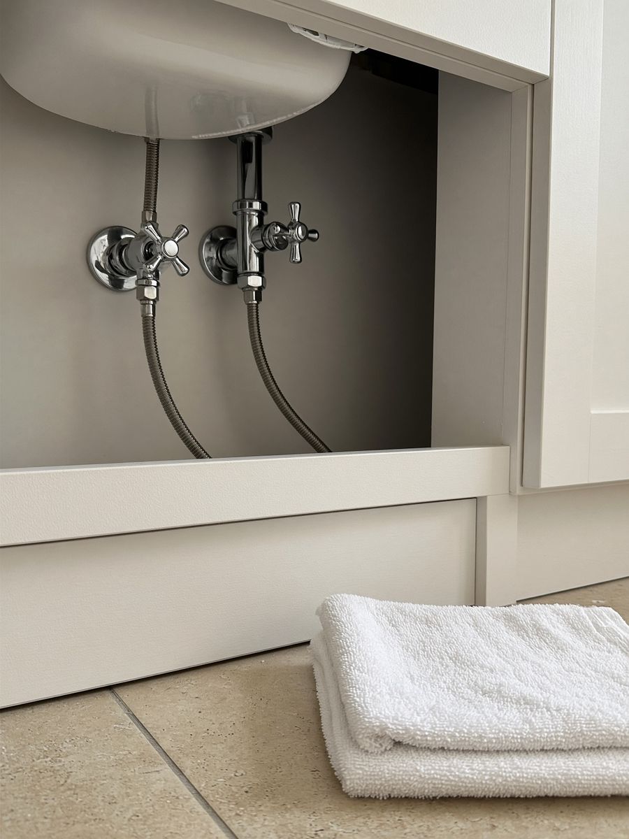 Shutoff valves under a bathroom sink